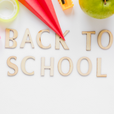 Felt tip marker point on words Back To School with apple and pencil sharpener at the top